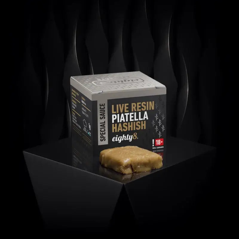 Eighty8 Piatella Live Resin Hash product box and hash on a black background, showcasing premium CBD quality.