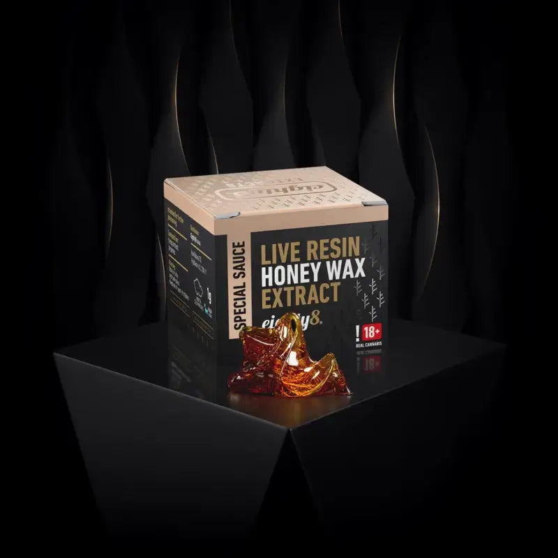 CBD Live Resin Honey Wax extract in a golden jar on a dark background, emphasizing its premium quality.